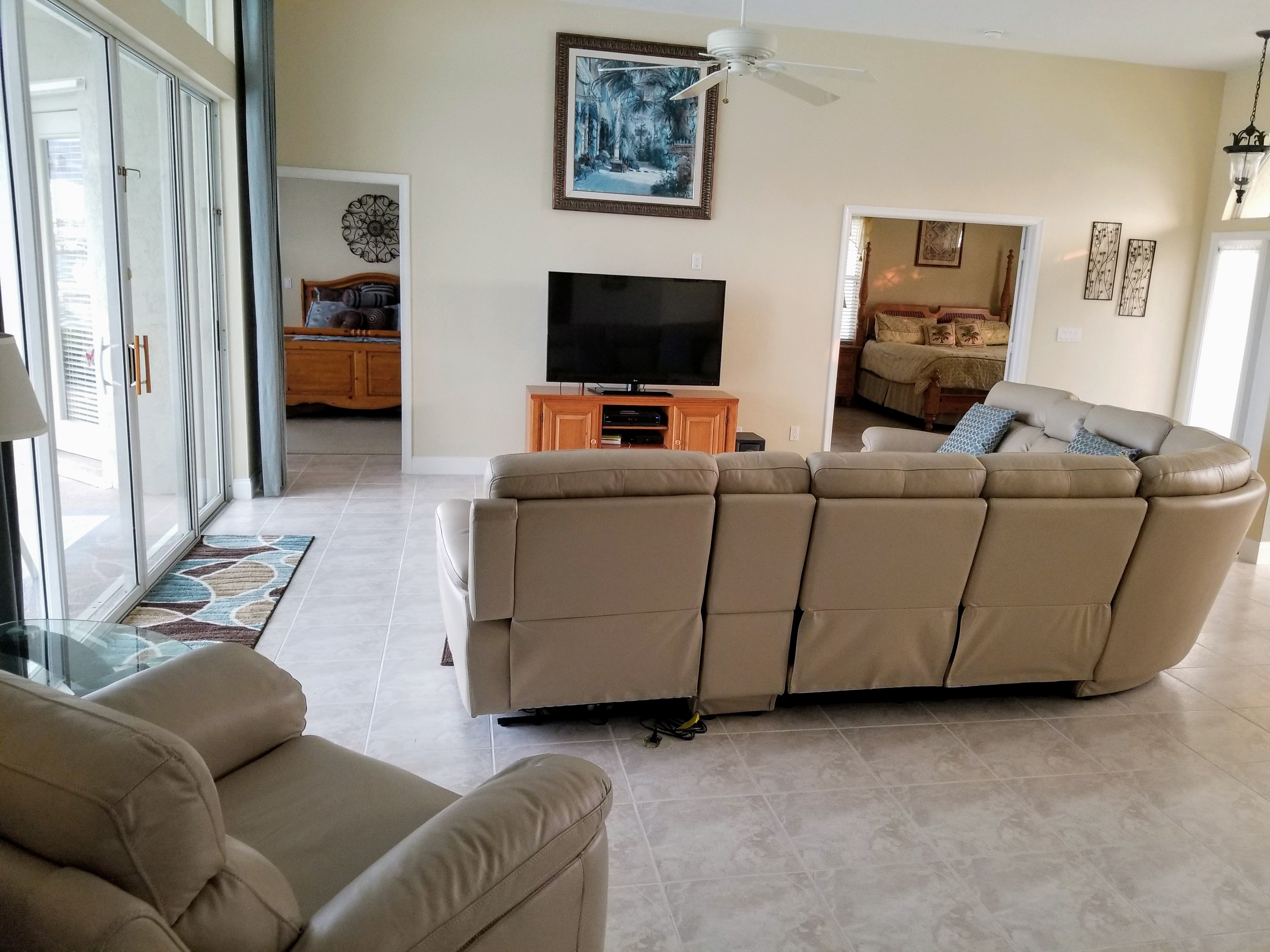 Open Family Room with view out over the patio and pool